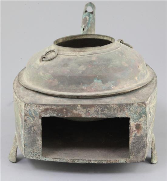 A Chinese archaic bronze steamer vessel, in two parts, Xian, Han dynasty, 206 B.C.-220 A.D., 30cm long, holes